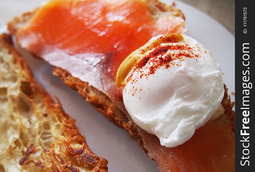 Poached eggs on toast with watercress and pepper.. Spain