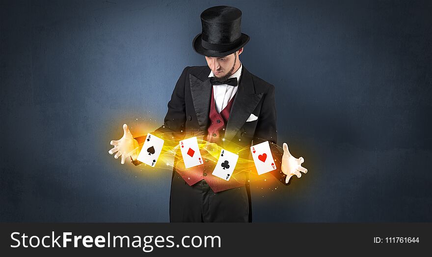 Illusionist making trick with magical play cards