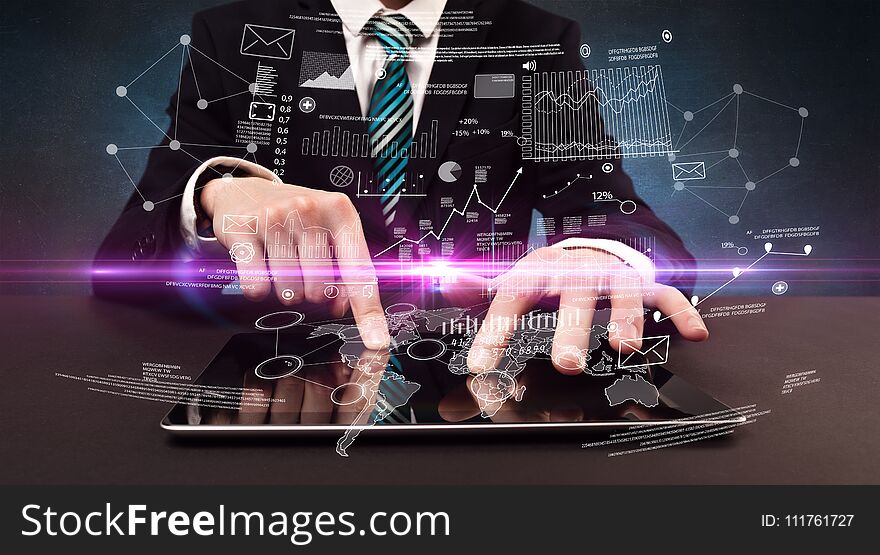 Businessman in formal attire typing with financial concept around. Businessman in formal attire typing with financial concept around