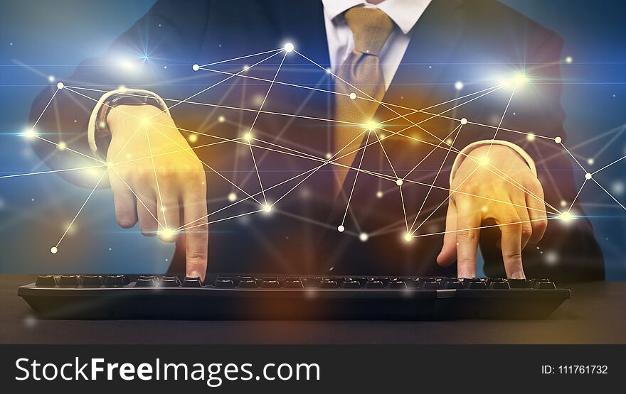 Businessman in suit typing with connection graphics around. Businessman in suit typing with connection graphics around