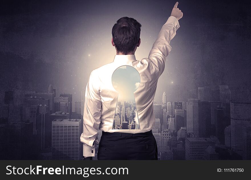Young businessman standing and thinking with keyhole on his back and city graphic around. Young businessman standing and thinking with keyhole on his back and city graphic around