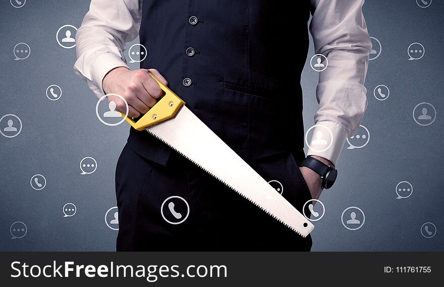 Thoughtful businesman holding tool with communication symbols around. Thoughtful businesman holding tool with communication symbols around