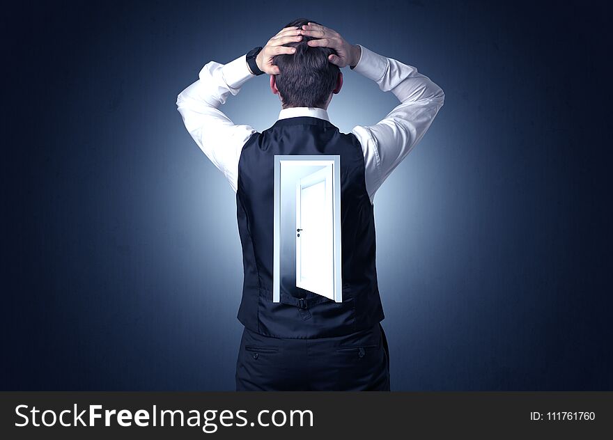 Businessman standing with door on his back