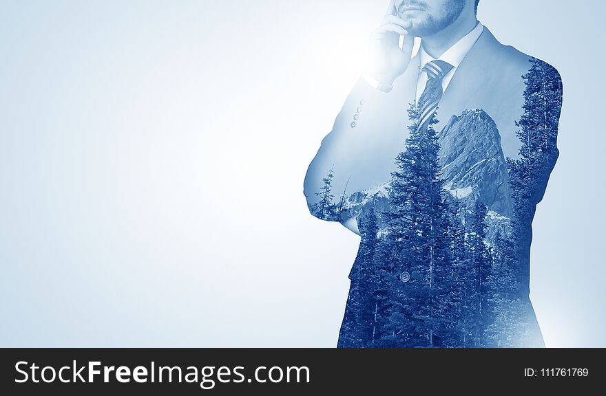 Young businessman standing and meditate with trees on the background. Young businessman standing and meditate with trees on the background
