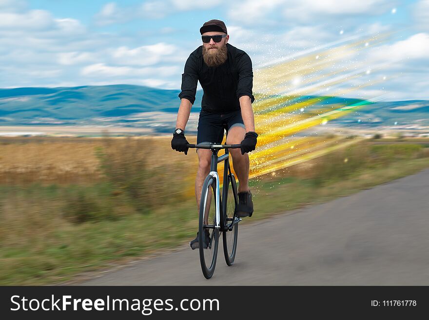 Young riding bicycle in fabulous nature with high speed. Young riding bicycle in fabulous nature with high speed