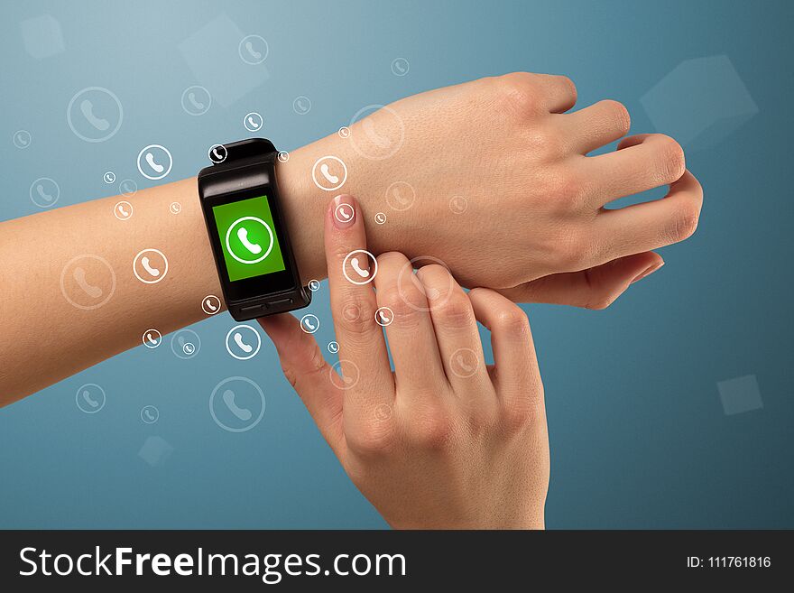 Female handwearing a ringing smartwatch with call icons around. Female handwearing a ringing smartwatch with call icons around