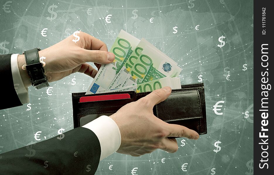 Businessman`s hand takes out euro from a wallet with global exchange graphic. Businessman`s hand takes out euro from a wallet with global exchange graphic
