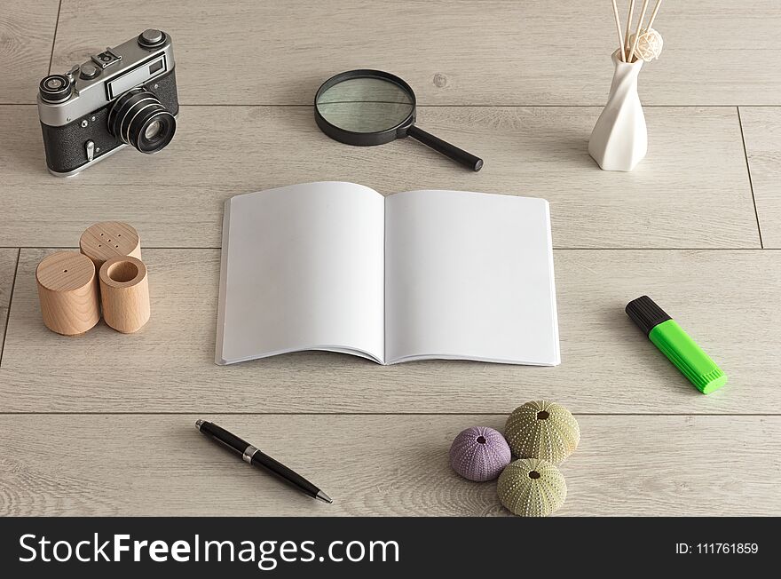 Empty notebook on wood floor with office tools nearby. Empty notebook on wood floor with office tools nearby