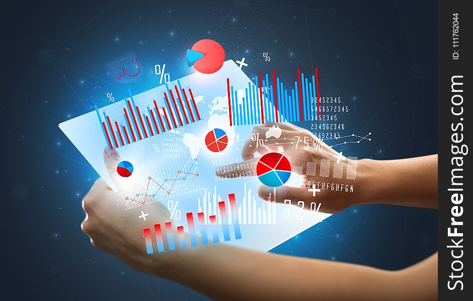 Hands touching a glass-like tablet with charts