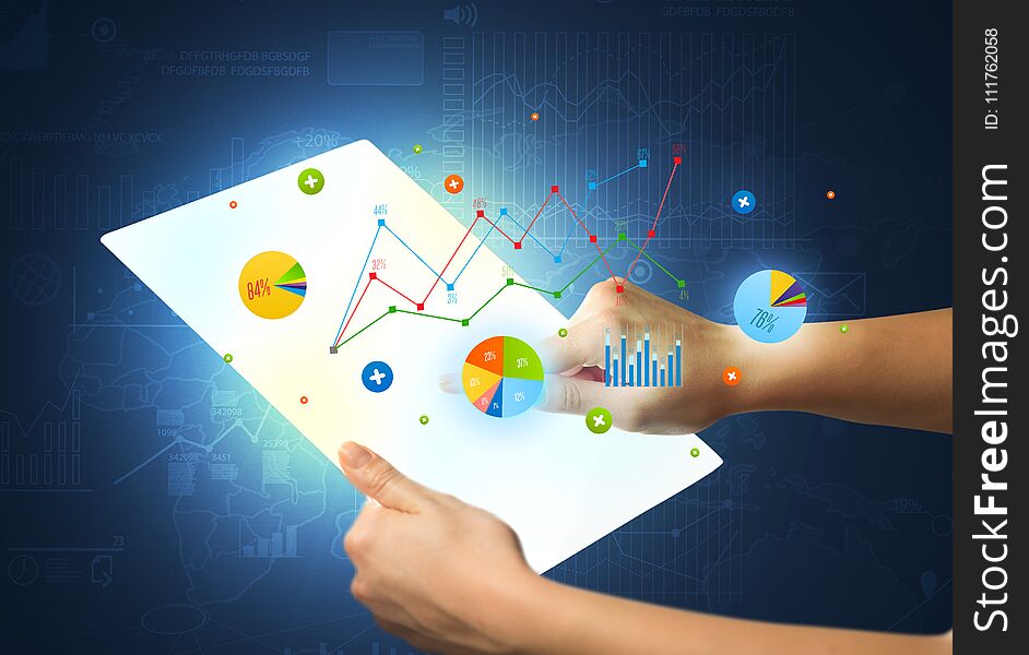 Hands Touching A Glass-like Tablet With Charts