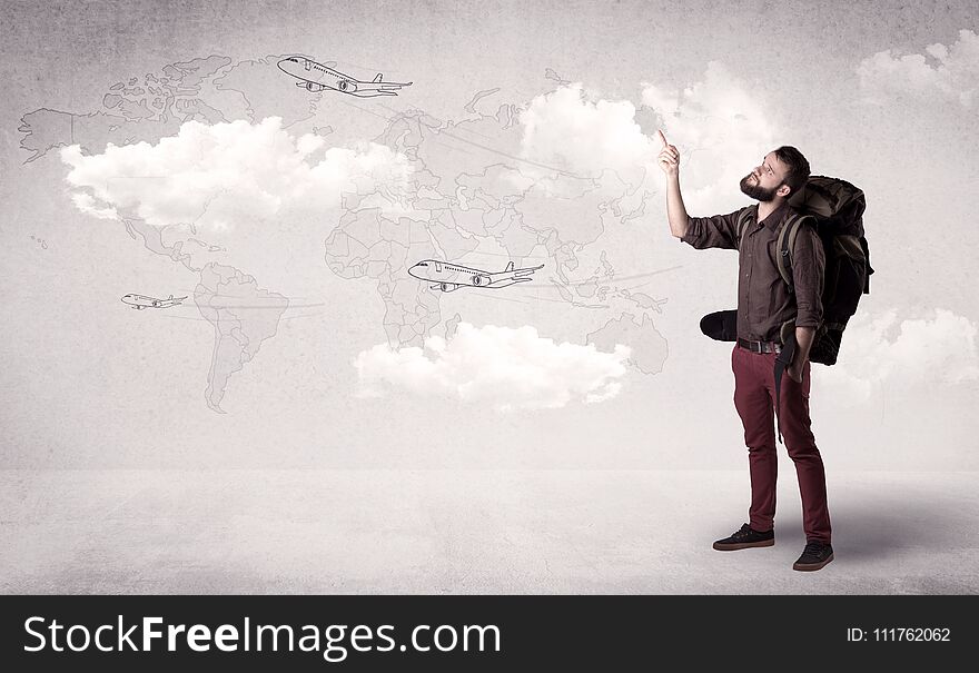 Handsome young man standing with a backpack on his back and planes in front of a world map as a background. Handsome young man standing with a backpack on his back and planes in front of a world map as a background