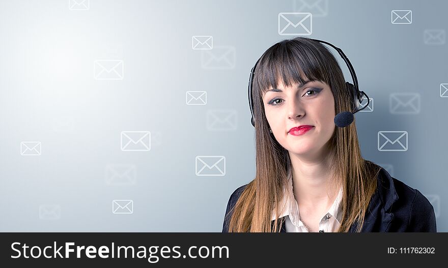 Young female telemarketer with white envelopes surrounding her
