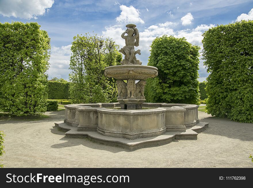 Flower gardens in french style and lion fountain in Kromeriz, Czech republic, Europe, historic sculptures