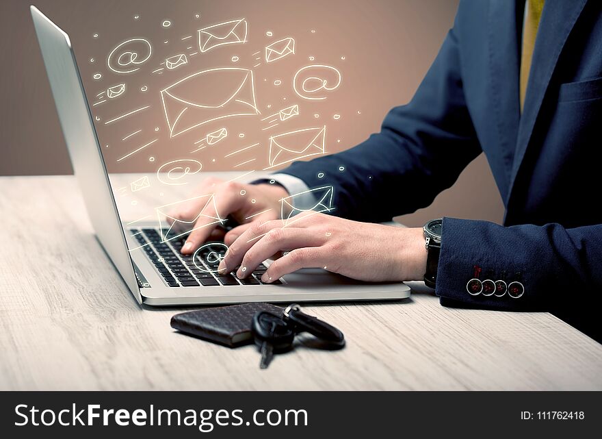 An office worker sending emails and communication with clients with the help of a portable laptop on desk concept. An office worker sending emails and communication with clients with the help of a portable laptop on desk concept