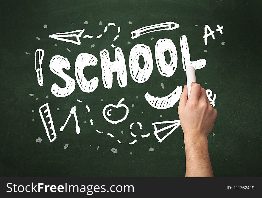 A teacher writing school, drawing children things on clean green chalkboard by hand. A teacher writing school, drawing children things on clean green chalkboard by hand