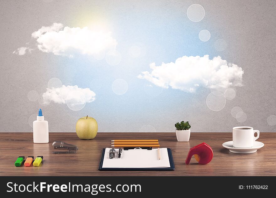 Bright sky with clouds and office desk