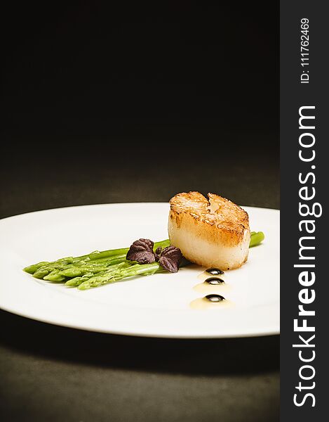 Scallop With Green Asparagus On White Plate