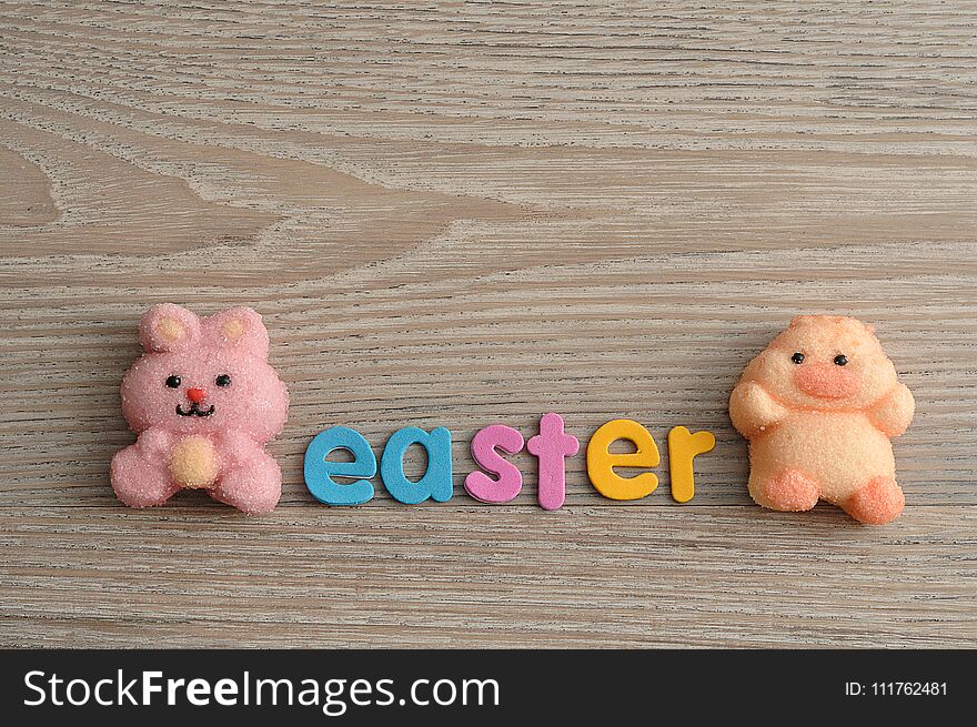 A pink bunny shape marshmallow and a chicken shape marshmallow with the word easter