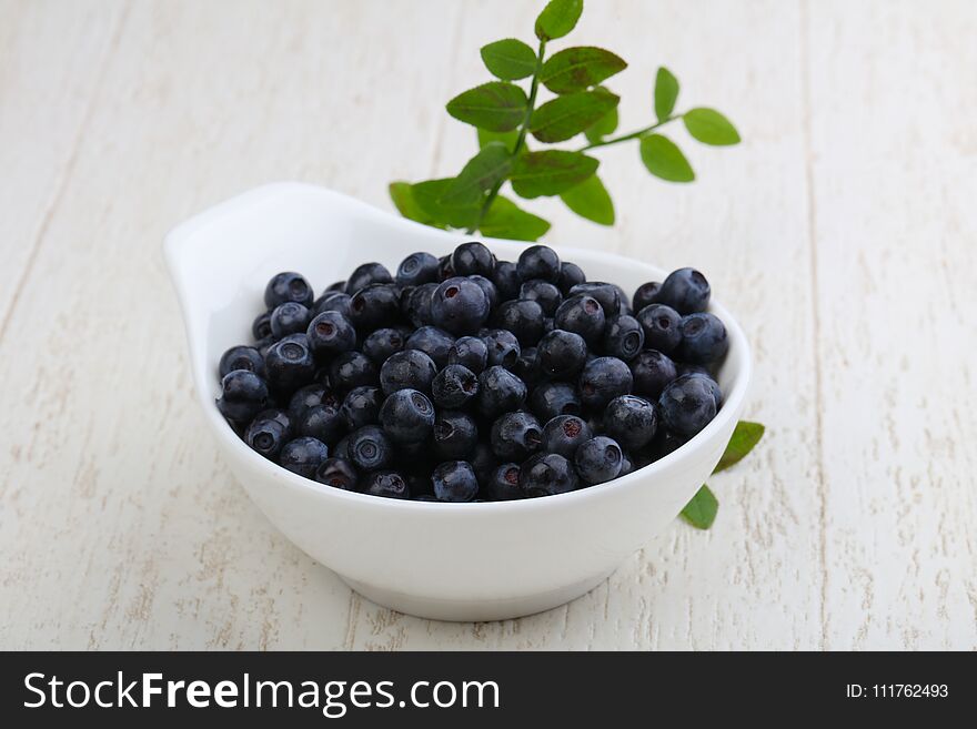 Blueberry heap with leaves in the bowl