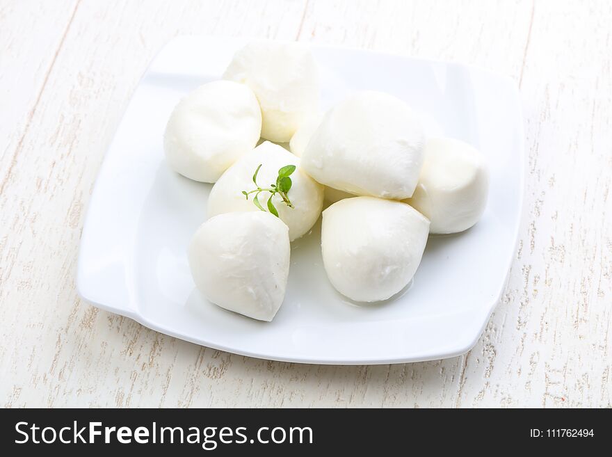 Mozzarella cheese with thyme branch on the white background