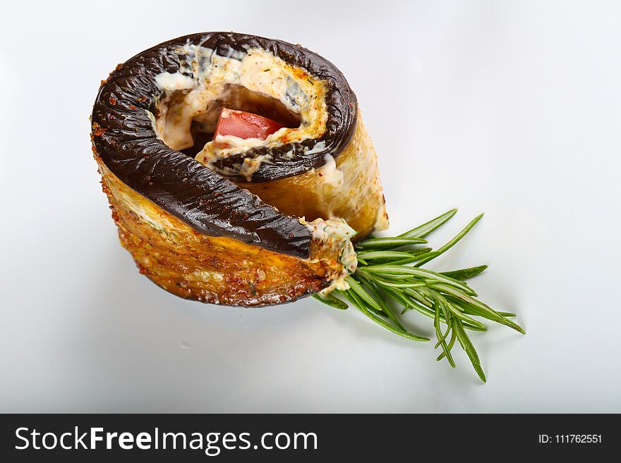 Stuffed eggplant with tomato and rosemary branch