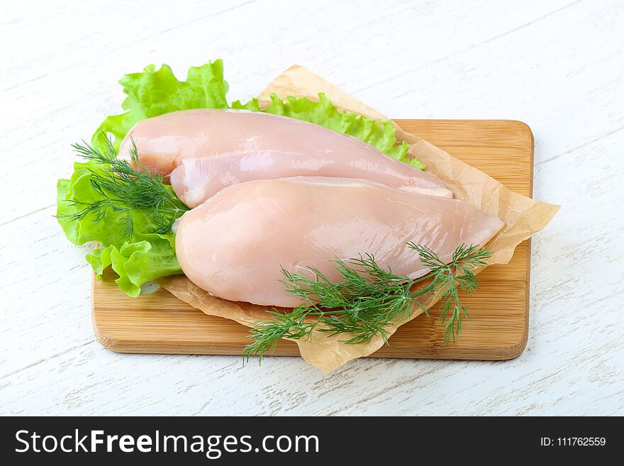 Raw chicken breast with dill ready for cooking
