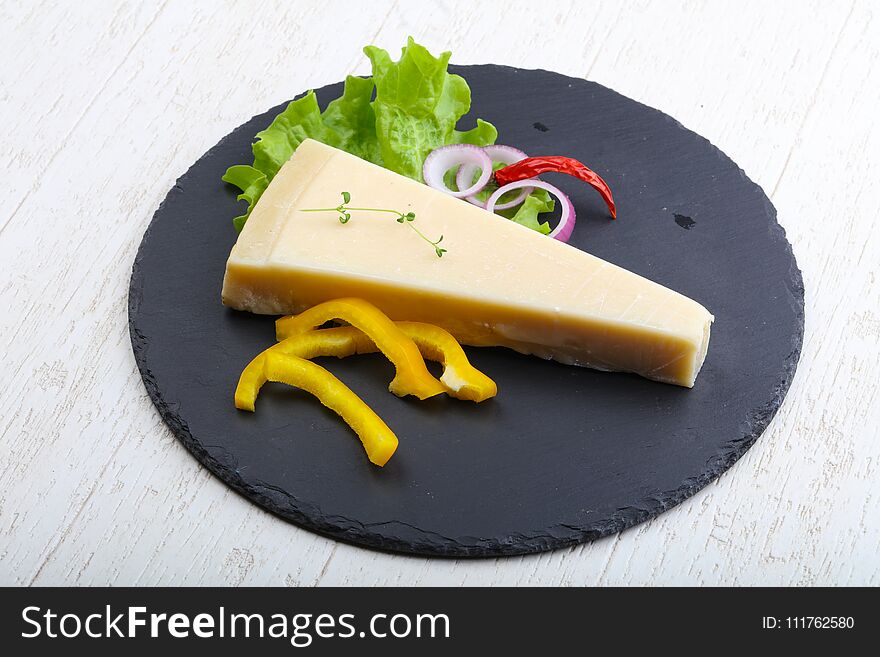 Parmesan cheese triangle on the wood background