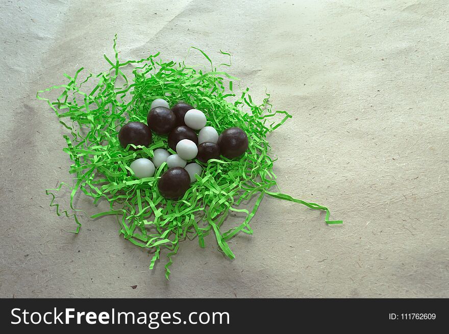 Chocolate and white candies on craft paper