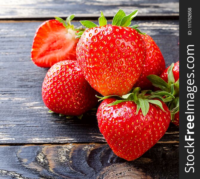 Sweet and fresh strawberry on dark background. Natural food. Square. Close-up.