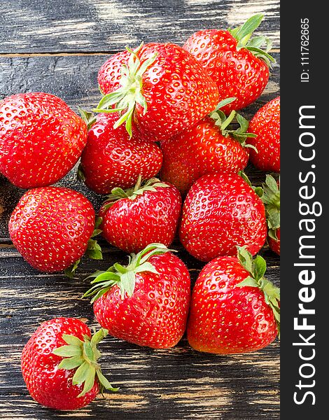 Sweet and fresh strawberry on dark background. Natural food. Vertical.