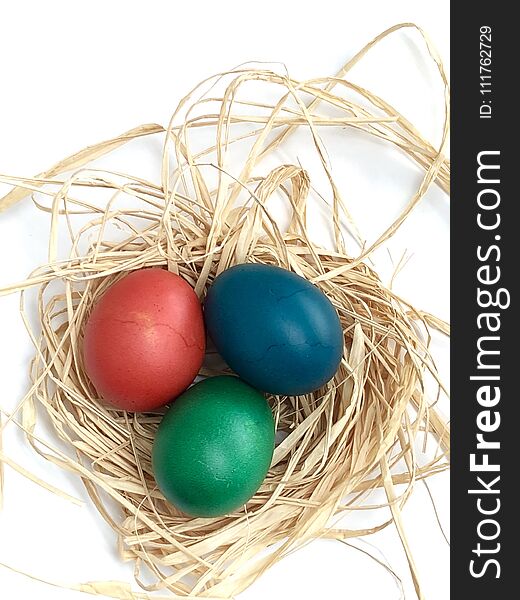 Easter eggs in a nest and with white background. Easter eggs in a nest and with white background