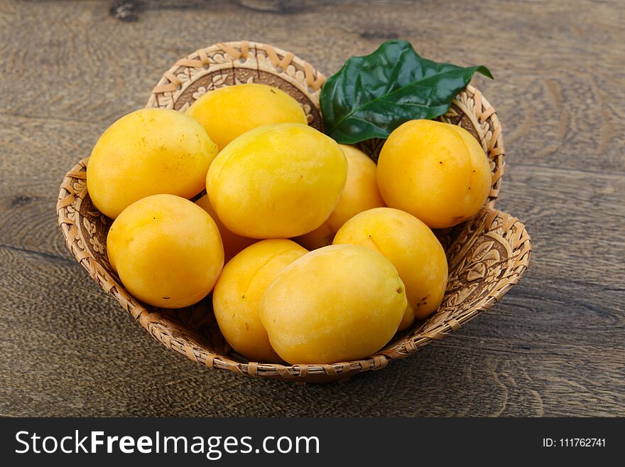 Fresh ripe sweet yellow apricots on the wood background. Fresh ripe sweet yellow apricots on the wood background