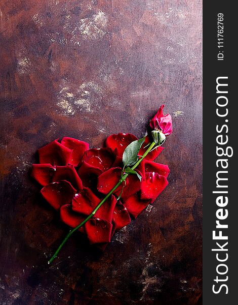 Top View Flat Lay Red Rose Petals In Heart Shape On Dark Background. Romance, Passion Concept. Valentines Day