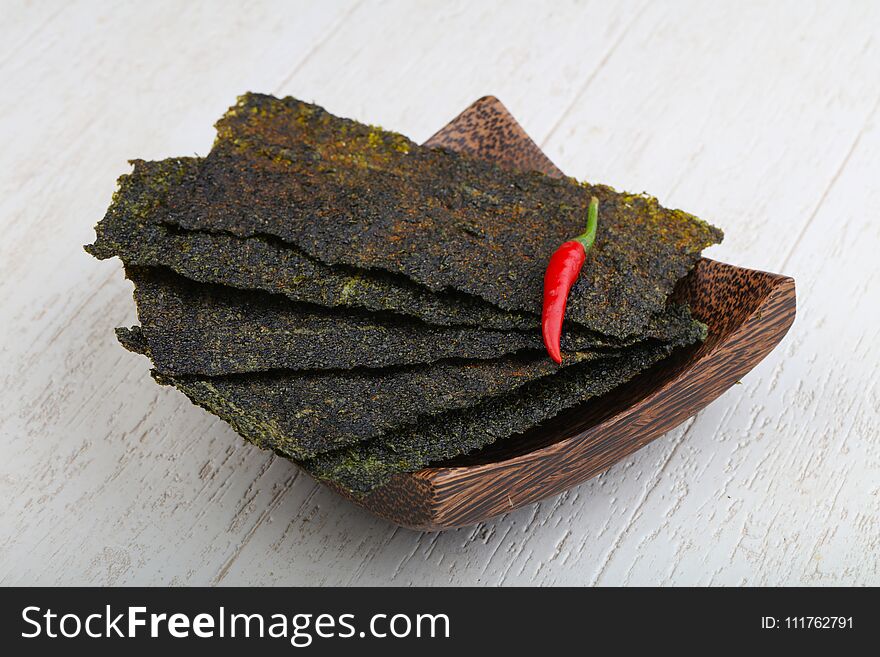 Spicy Nori seaweed sheets with pepper on wood