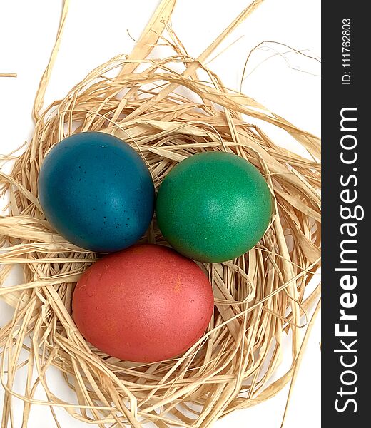 Easter eggs in a nest and white background. Easter eggs in a nest and white background
