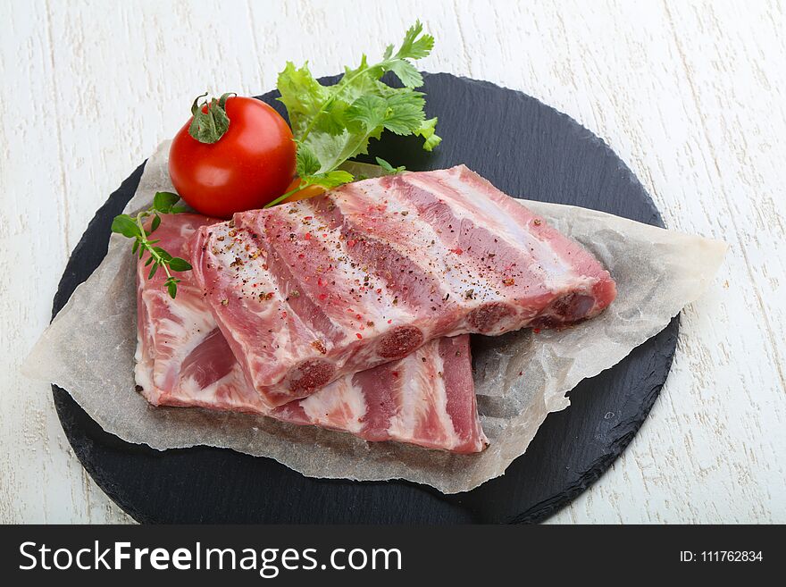 Raw pork ribs with herbs and spices