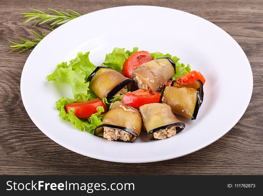 Eggplant rolls with walnuts, chicken and tomato