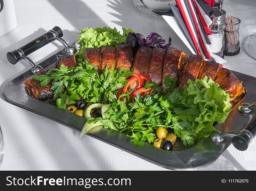 Delicious celebration dish with parsley and olives on metal tray. Delicious celebration dish with parsley and olives on metal tray