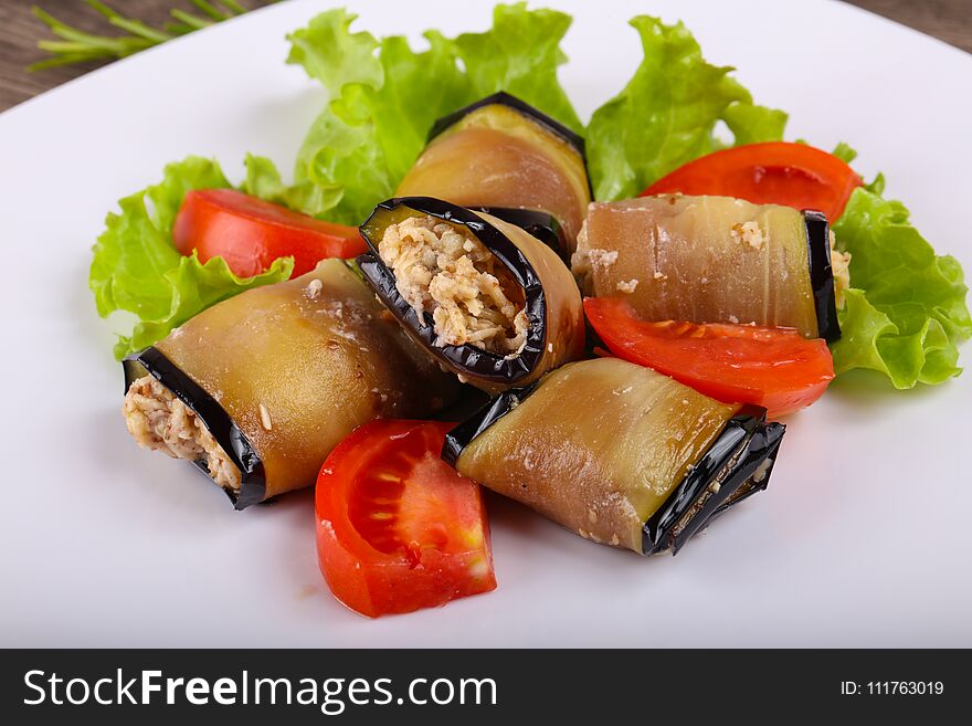 Eggplant rolls with walnuts, chicken and tomato