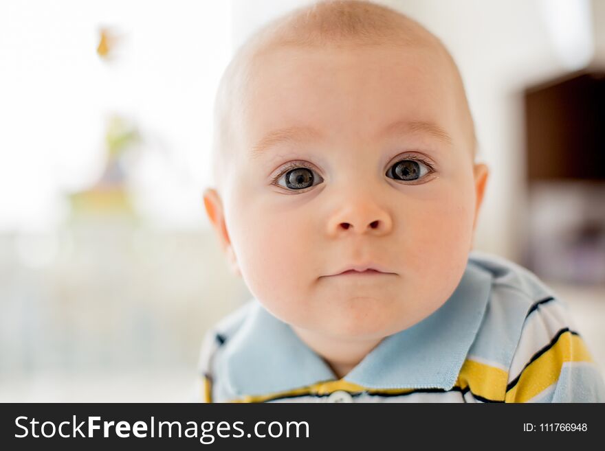 Portrait of a cute smiling infant baby boy. Happy childhood concept.