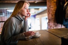 Young Beauty Woman In A Cafe Drinking Coffee Stock Photo