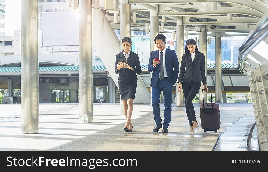 Team of business people smart man and woman walk in rush hour at