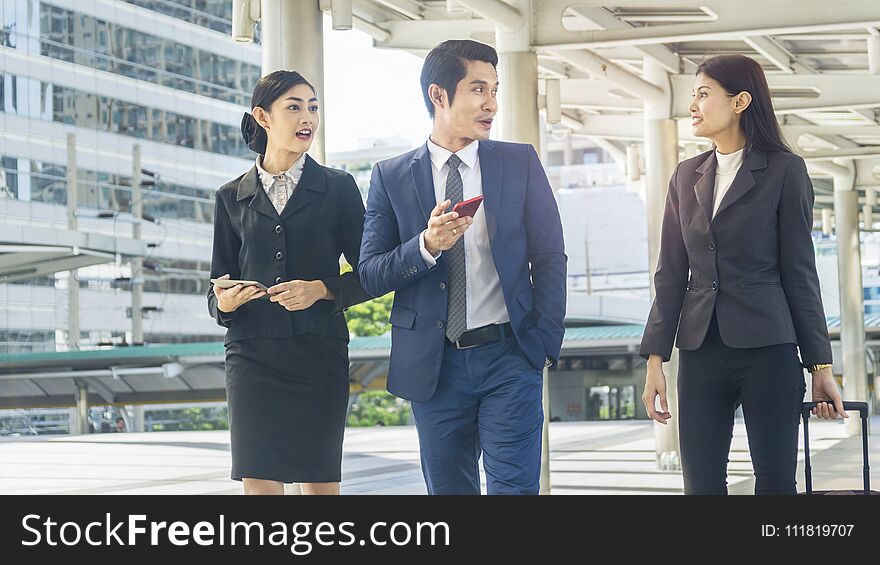 Team of business people smart man and woman walk in rush hour at