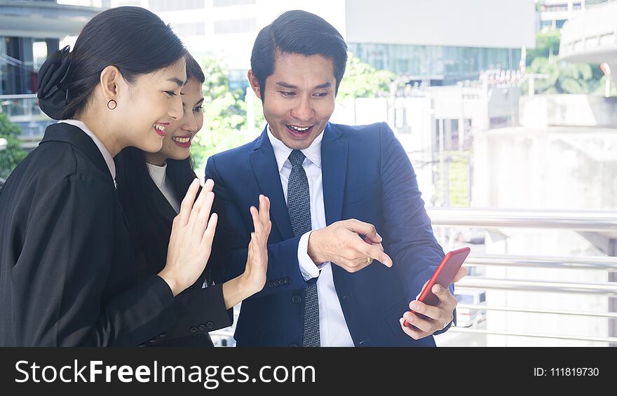 Group smart business people of men and women talk together and video call yourself in feeling happy with tablet smart phone device at the outdoor pedestrian walkway space in the morning. Group smart business people of men and women talk together and video call yourself in feeling happy with tablet smart phone device at the outdoor pedestrian walkway space in the morning.