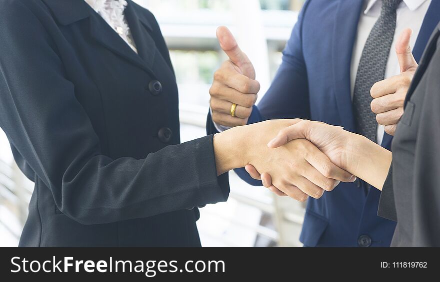 Group of business people of men and women with business suit stand and hold hands together. Group of business people of men and women with business suit stand and hold hands together