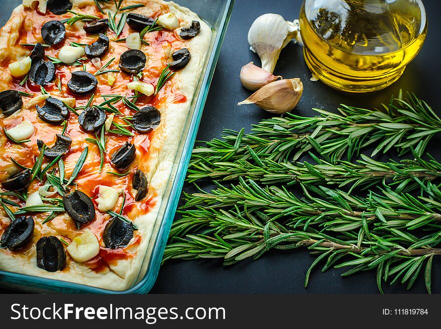 Traditional Italian vegetarian focaccia of homemade bread with olives, rosemary
