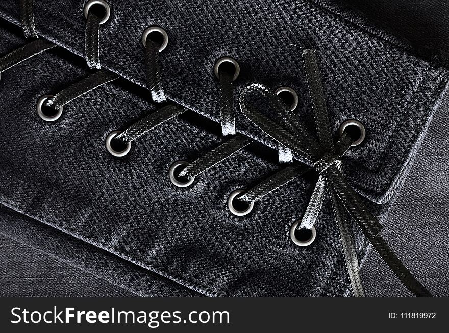 Washed black denim, lace-up details. Jeans background, texture