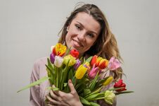 Young Charming Girl With A Bouquet Of Flowers - Multi-colored Tulips Stock Image