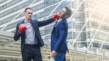 Two Business Mans Are Fighting With Boxing Glove At Outdoor City Stock Photography
