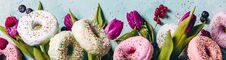 Sweet And Colourful Doughnuts With Sprinkles, Purple Tulips And Royalty Free Stock Image